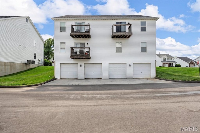 628 Homerun Dr Unit 11N, Ofallon, MO 63366 - view of front of house featuring a balcony, a garage, and a front yard