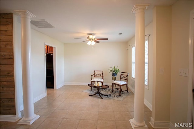 1106 Tulip Trce, Sikeston, MO 63801 - living area with decorative columns, ceiling fan, and light tile patterned floors