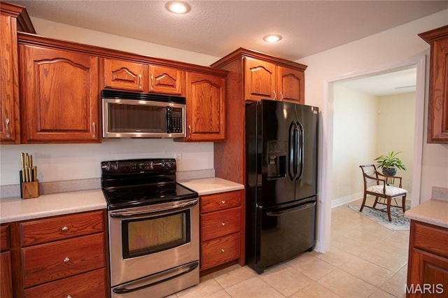 1106 Tulip Trce, Sikeston, MO 63801 - kitchen featuring appliances with stainless steel finishes, light countertops, light tile patterned floors, and recessed lighting