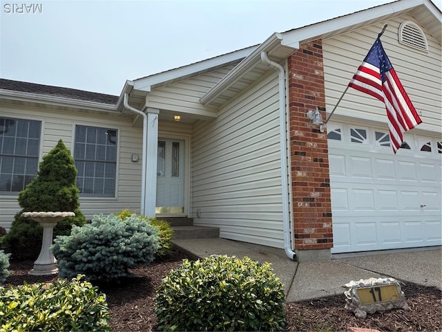 17 Battersea Ct Unit 6B, Ofallon, MO 63366 - view of exterior entry with brick siding and a garage