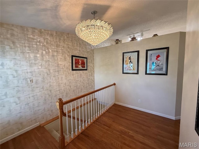 17 Battersea Ct Unit 6B, Ofallon, MO 63366 - stairway with a chandelier, wood finished floors, and a textured ceiling