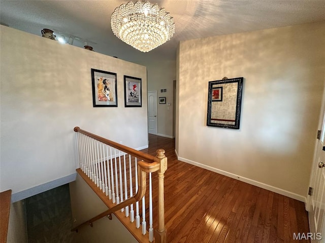 17 Battersea Ct Unit 6B, Ofallon, MO 63366 - stairway featuring a chandelier and hardwood / wood-style floors