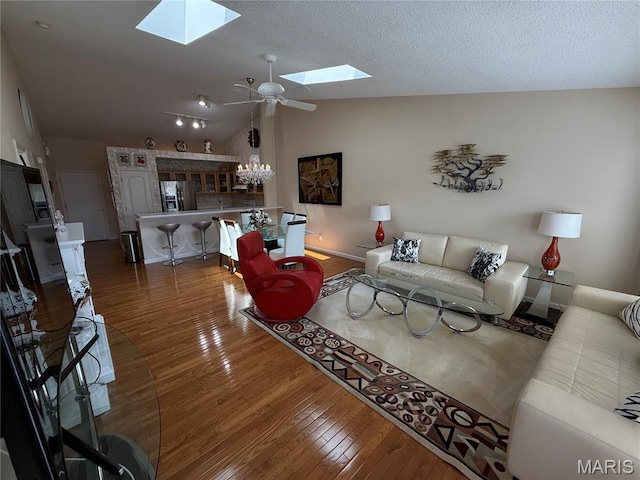 17 Battersea Ct Unit 6B, Ofallon, MO 63366 - living area with a skylight, lofted ceiling, hardwood / wood-style flooring, and a ceiling fan