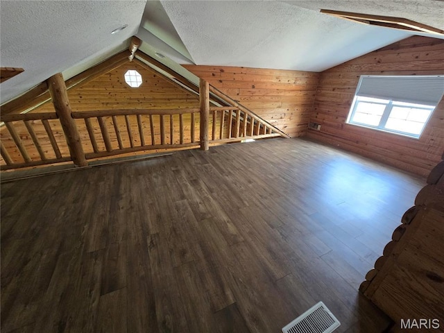 1505 Holloway St, Rolla, MO 65401 - additional living space with vaulted ceiling, wood walls, a textured ceiling, and dark wood-type flooring