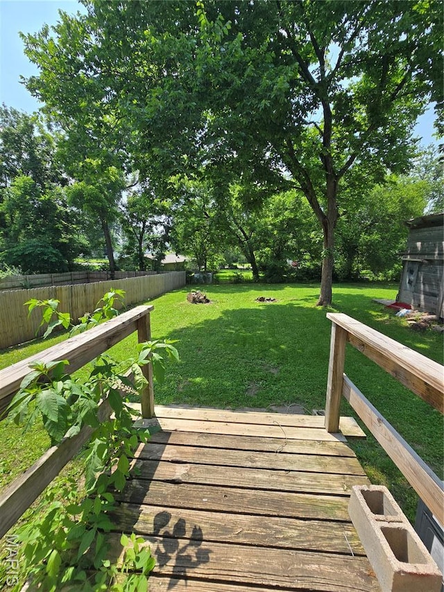 1505 Holloway St, Rolla, MO 65401 - fenced yard featuring a deck and view of scattered trees