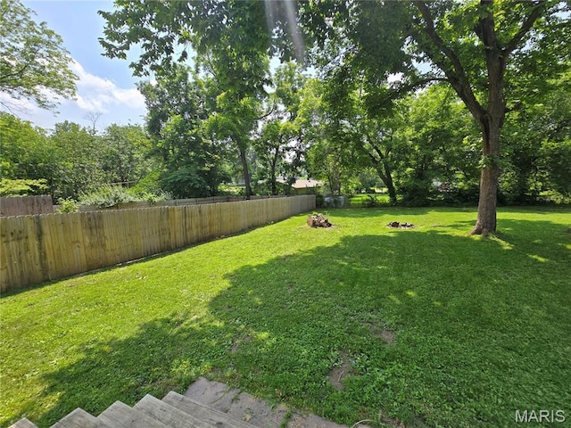 1505 Holloway St, Rolla, MO 65401 - fenced backyard with an outdoor fire pit