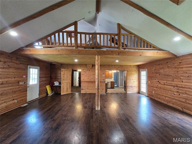 1505 Holloway St, Rolla, MO 65401 - unfurnished living room featuring high vaulted ceiling, beam ceiling, wood finished floors, plenty of natural light, and wooden walls