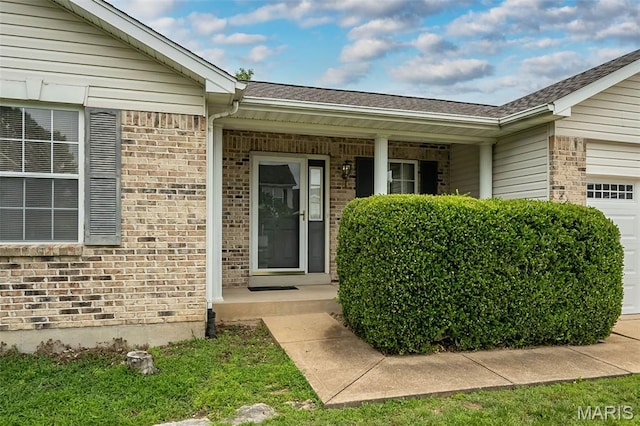 425 Bluffview Hts, Arnold, MO 63010 - doorway to property featuring a garage, brick siding, a porch, and roof with shingles