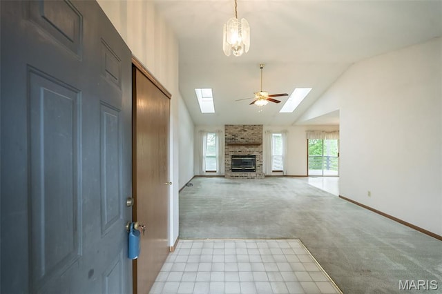 425 Bluffview Hts, Arnold, MO 63010 - unfurnished living room with a skylight, light carpet, vaulted ceiling, a brick fireplace, and ceiling fan