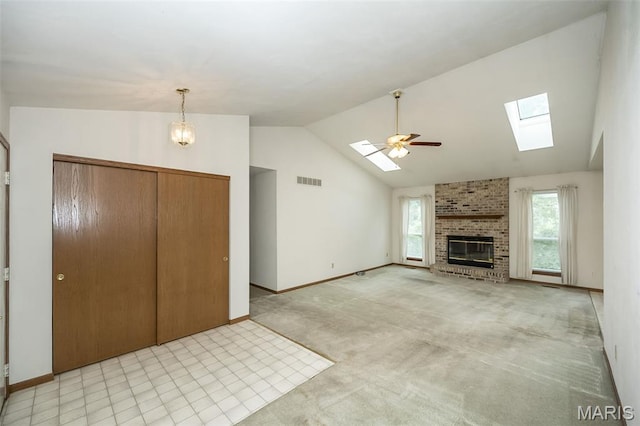 425 Bluffview Hts, Arnold, MO 63010 - unfurnished living room with a skylight, a fireplace, a ceiling fan, and high vaulted ceiling
