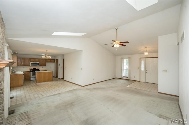 425 Bluffview Hts, Arnold, MO 63010 - unfurnished living room featuring a skylight, light carpet, vaulted ceiling, and a chandelier