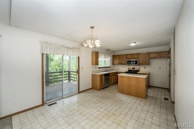 425 Bluffview Hts, Arnold, MO 63010 - kitchen with appliances with stainless steel finishes, brown cabinets, light countertops, and a chandelier