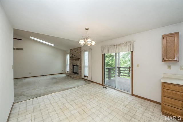 425 Bluffview Hts, Arnold, MO 63010 - unfurnished living room featuring a chandelier, light carpet, a fireplace, light flooring, and lofted ceiling