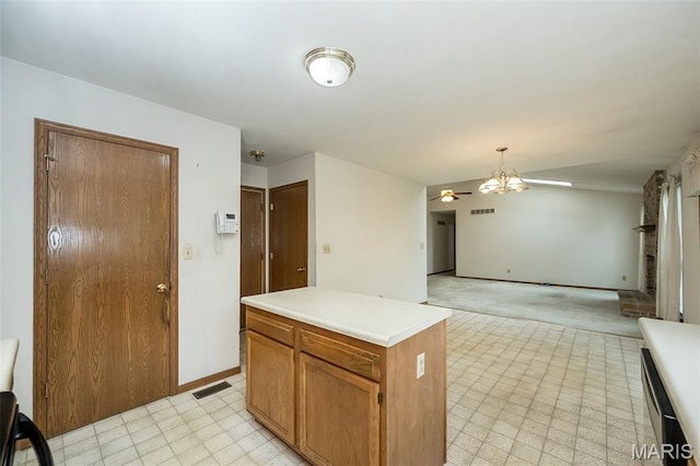 425 Bluffview Hts, Arnold, MO 63010 - kitchen with a ceiling fan, light countertops, a chandelier, open floor plan, and pendant lighting