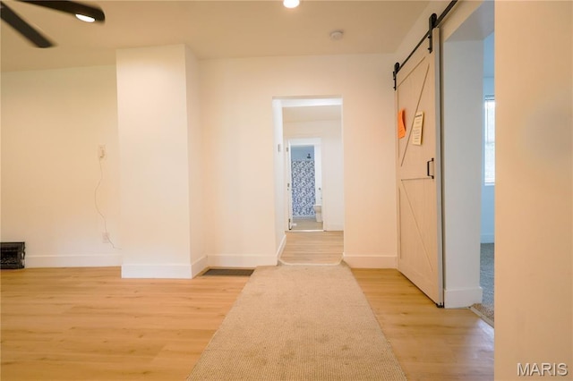 5444 Janet Ave, Jennings, MO 63136 - hallway with a barn door, light wood-type flooring, and recessed lighting