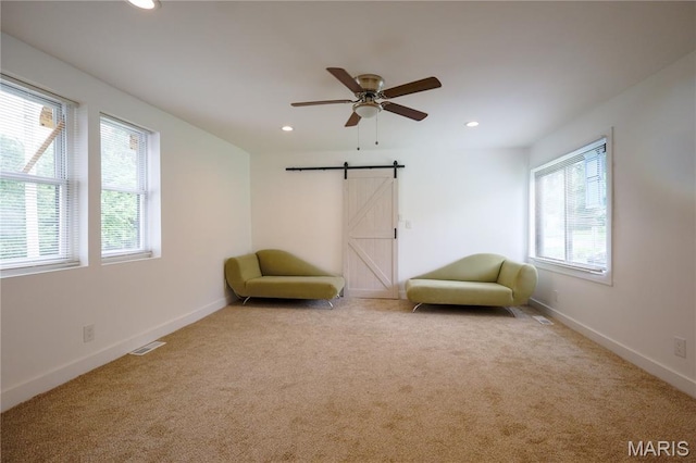 5444 Janet Ave, Jennings, MO 63136 - living area featuring carpet floors, recessed lighting, ceiling fan, and a barn door