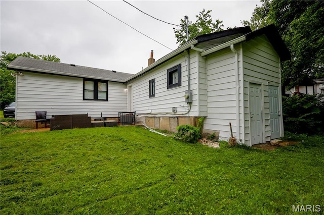5444 Janet Ave, Jennings, MO 63136 - rear view of house featuring a yard and a chimney