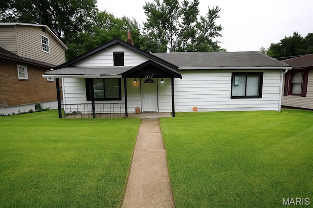 5444 Janet Ave, Jennings, MO 63136 - view of front of property featuring roof with shingles, a front yard, and covered porch