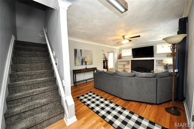 5241 Devonshire Ave, Saint Louis, MO 63109 - living room featuring stairway, ceiling fan, wood finished floors, a fireplace, and ornamental molding