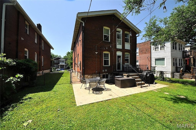 5241 Devonshire Ave, Saint Louis, MO 63109 - rear view of house with a patio and brick siding