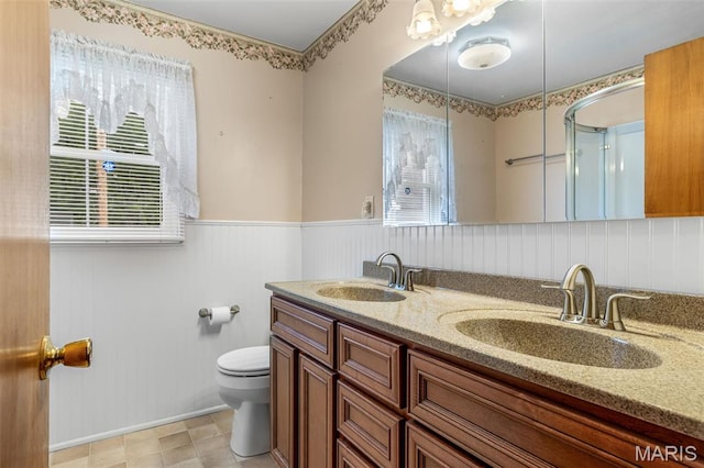 715 S A St, Farmington, MO 63640 - full bathroom featuring plenty of natural light, double vanity, and wainscoting