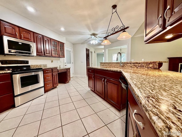 17138 E Cedar Hills Dr, Dexter, MO 63841 - kitchen with appliances with stainless steel finishes, light tile patterned floors, ceiling fan, light stone countertops, and glass insert cabinets