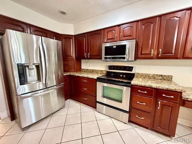 17138 E Cedar Hills Dr, Dexter, MO 63841 - kitchen with stainless steel appliances, light stone countertops, light tile patterned flooring, and reddish brown cabinets