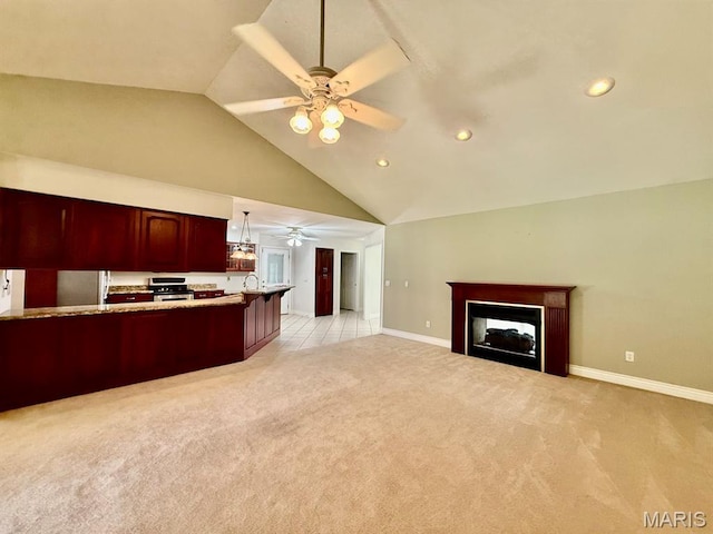 17138 E Cedar Hills Dr, Dexter, MO 63841 - kitchen featuring ceiling fan, light carpet, freestanding refrigerator, a fireplace, and open floor plan