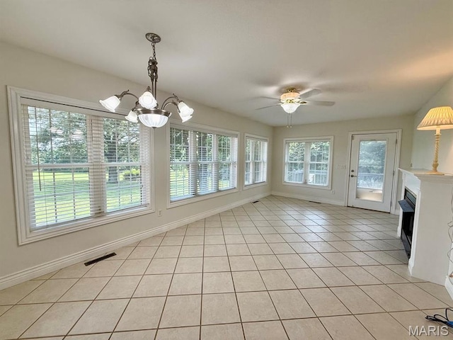 17138 E Cedar Hills Dr, Dexter, MO 63841 - unfurnished dining area with light tile patterned floors, a chandelier, ceiling fan, and a fireplace
