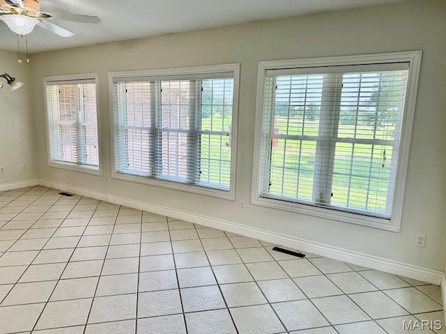 17138 E Cedar Hills Dr, Dexter, MO 63841 - empty room featuring a ceiling fan, plenty of natural light, and light tile patterned floors