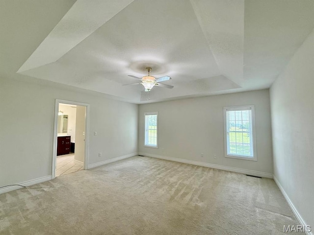 17138 E Cedar Hills Dr, Dexter, MO 63841 - unfurnished room with a tray ceiling, light carpet, and a ceiling fan