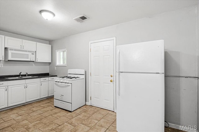 14 Lillian Dr, Belleville, IL 62226 - kitchen featuring white appliances, white cabinets, and dark countertops