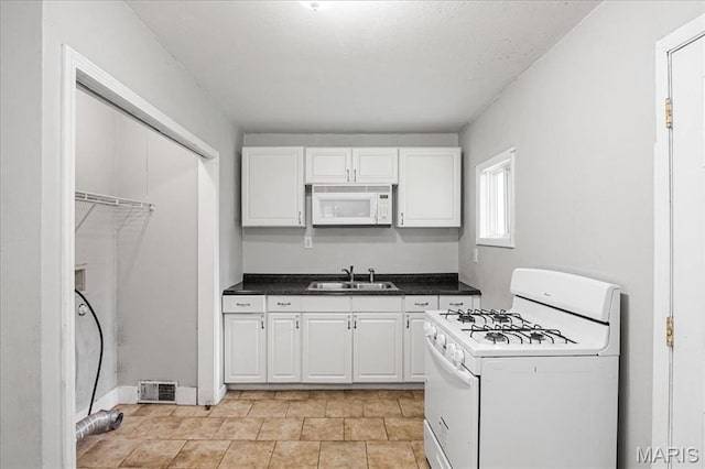14 Lillian Dr, Belleville, IL 62226 - kitchen featuring white appliances, white cabinetry, and dark countertops