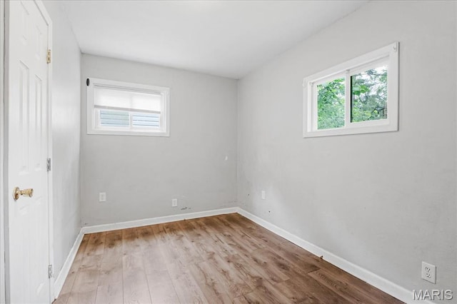 14 Lillian Dr, Belleville, IL 62226 - unfurnished bedroom with multiple windows and wood finished floors
