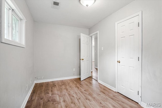 14 Lillian Dr, Belleville, IL 62226 - unfurnished bedroom with light wood-style floors and baseboards