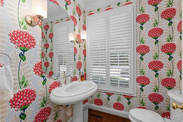 248 Gay Ave, Clayton, MO 63105 - half bathroom featuring ornamental molding, wallpapered walls, and wood finished floors
