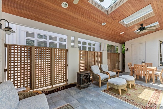248 Gay Ave, Clayton, MO 63105 - sunroom featuring a skylight, vaulted ceiling, and a wood stove