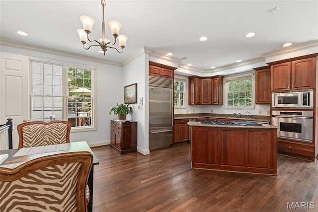 248 Gay Ave, Clayton, MO 63105 - kitchen with built in appliances, a chandelier, dark wood finished floors, ornamental molding, and a center island
