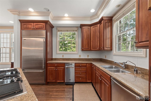 248 Gay Ave, Clayton, MO 63105 - kitchen featuring appliances with stainless steel finishes, crown molding, dark wood-style floors, brown cabinets, and recessed lighting