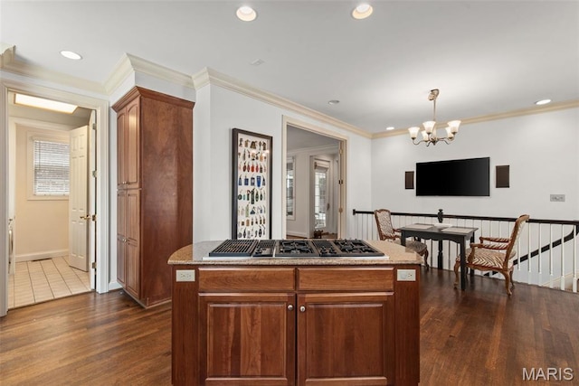 248 Gay Ave, Clayton, MO 63105 - kitchen with dark wood finished floors, stainless steel gas cooktop, a chandelier, recessed lighting, and light stone countertops