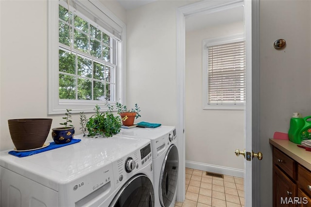 248 Gay Ave, Clayton, MO 63105 - laundry area featuring washer and dryer, healthy amount of natural light, and light tile patterned flooring