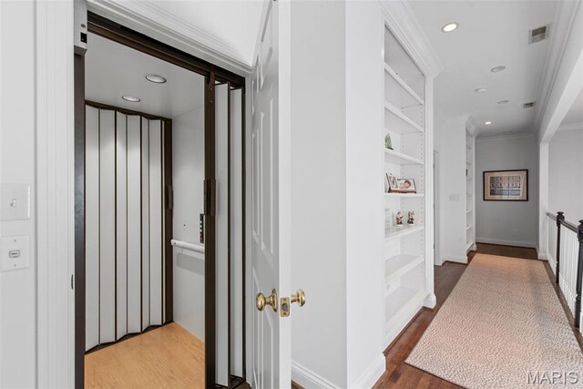 248 Gay Ave, Clayton, MO 63105 - hallway featuring ornamental molding, wood finished floors, recessed lighting, and built in features
