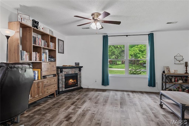 1939 Grandview Dr, Cape Girardeau, MO 63701 - office space featuring a ceiling fan, wood finished floors, a textured ceiling, and a fireplace