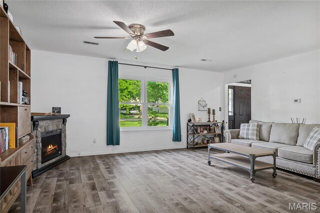 1939 Grandview Dr, Cape Girardeau, MO 63701 - living area with ceiling fan, a fireplace, wood finished floors, and a textured ceiling