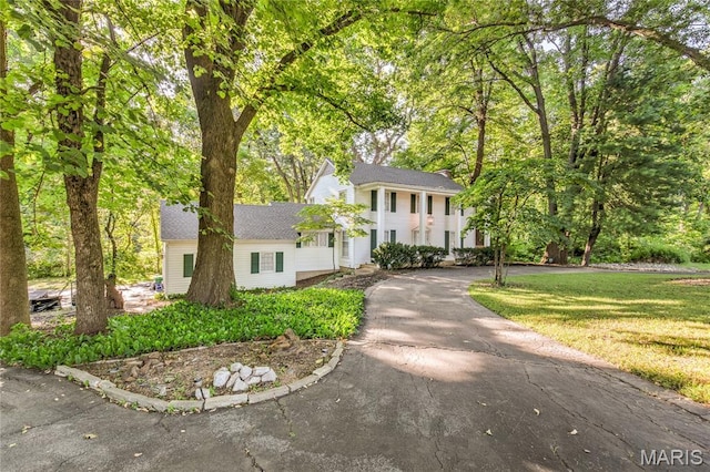 67 Kings Dr, Florissant, MO 63034 - neoclassical home featuring asphalt driveway and a front lawn