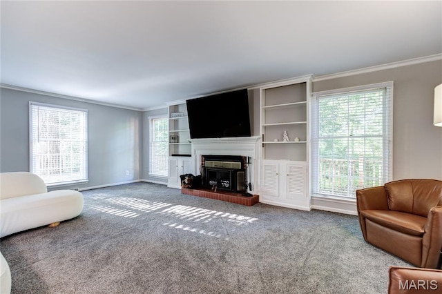 67 Kings Dr, Florissant, MO 63034 - living area with crown molding, carpet flooring, plenty of natural light, and a fireplace with raised hearth