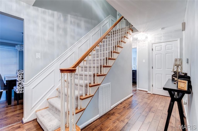 67 Kings Dr, Florissant, MO 63034 - stairway featuring wood-type flooring