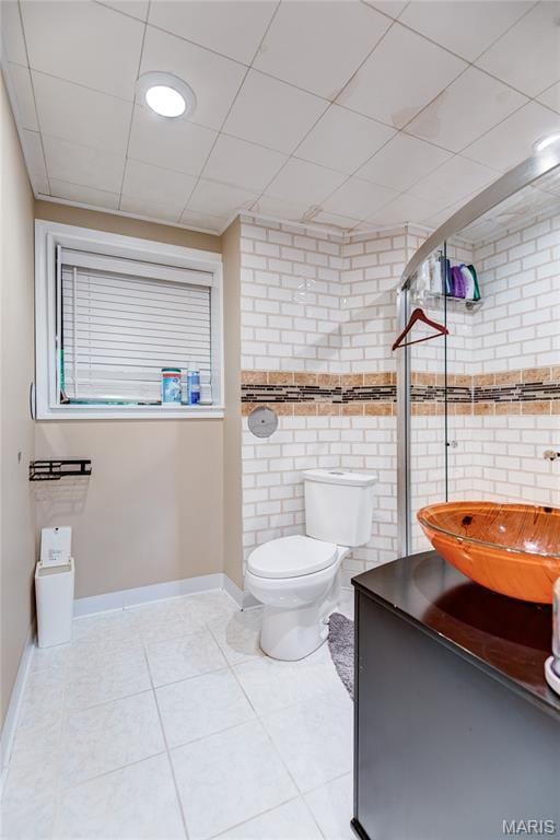 67 Kings Dr, Florissant, MO 63034 - bathroom with tile patterned flooring, vanity, and tile walls