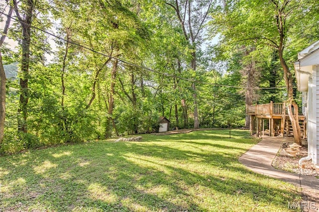 67 Kings Dr, Florissant, MO 63034 - view of green lawn with stairs, a wooden deck, and a storage shed