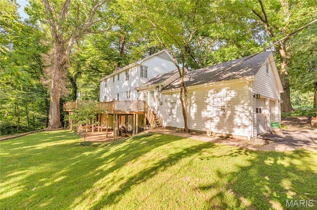 67 Kings Dr, Florissant, MO 63034 - rear view of house featuring stairs, a deck, a lawn, roof with shingles, and an attached garage